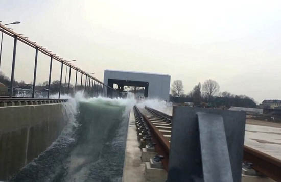 Scientists in the Netherlands have built a vast new machine that can create the world's largest artificial wave to put flood defences to the test.The new facility cost 26m Euros and took two years to build. It holds 9 million litres of water, pumped in from a reservoir at 1,000 litres a second.The waves are created by a 10m-high steel wall, that pushes the water back and forth.By making adjustments to this movement, waves can be made to order: from the choppy waters of stormy seas to a single tsunami surge.