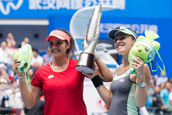 Sania Mirza & her Swiss partner Martina Hingis have clinched their seventh title together by winning the Wuhan Open women's doubles trophy.With this win, the Indo-Swiss pairing has seven WTA doubles titles together this year -- Indian Wells, Miami, Charleston, Wimbledon, the US Open, Guangzhou and Wuhan.They have won their last three tournaments and their last 13 matches without dropping a single set.
